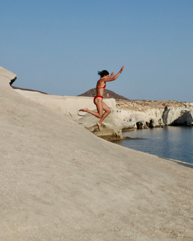 Girl jumps from a ledge in the Sarakiniko waters